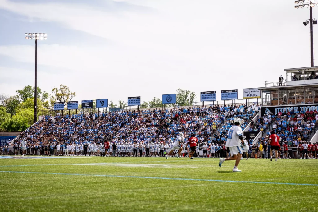 Hopkins lacrosse player on the field with packed stands